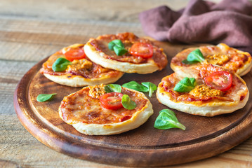 Mini pizzas on the wooden board