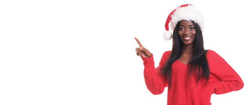 African model in santa claus hat is pointing by finger.