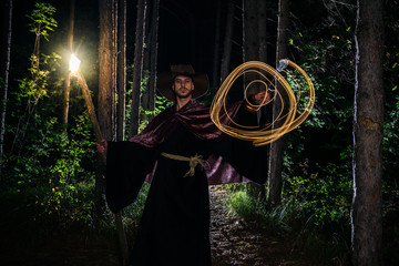 Obraz na płótnie Canvas Young man wearing halloween fantasy magician robes