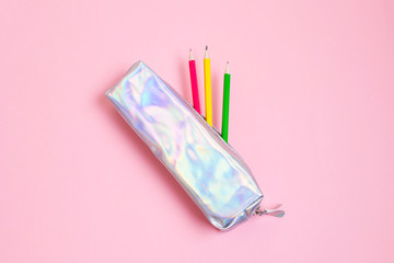 Mother of pearl pencil case with pink, yellow and green graphite pencils inside. Pastel pink...