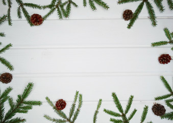 christmas decoration cones and garland lights on wooden background