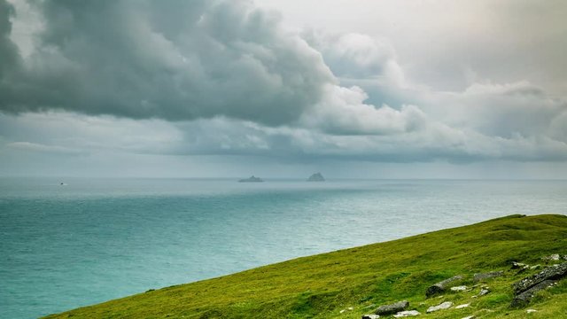 footage of bray head on the ring of kerry in the south coast of ireland on a stormy day showing battering waves and green grass on rocky coastline