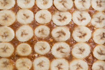 banana slices with chocolate mousse and caramel, banana background