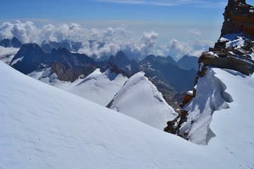 Gran Paradiso National Park, Italy. Climbing to the summit of mount Gran Paradiso 4 061 m with cats and ice ax. Sunny chilly day.