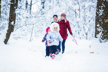 Fototapeta na wymiar Cute family having fun in the snow