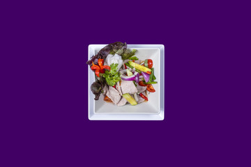 Asian Thai food on white plates with purple background with copy space