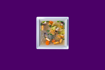 Fototapeta premium Asian Thai food on white plates with purple background with copy space