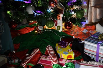 placing gifts under the tree and Christmas decorations