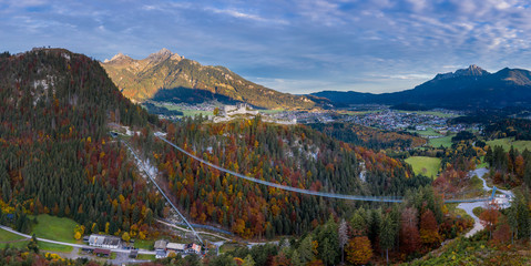 rope bridge to ruin castle ehrenberg with view to village reutte at fall