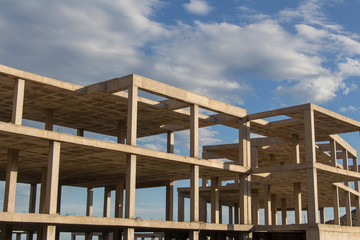 building construction site work from concrete, concrete structure of building under construction, concrete formwork, construction of the building, building construction site work against blue sky