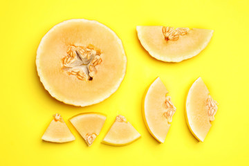 Flat lay composition with tasty melon on yellow background