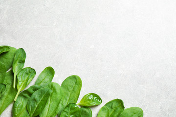 Fresh green healthy spinach on light table, flat lay. Space for text