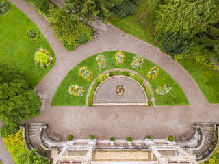 Aerial view of villa entrance with stairs and romantic luxury garden.