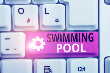 Writing note showing Swimming Pool. Business concept for Structure designed to hold water for leisure activities White pc keyboard with note paper above the white background