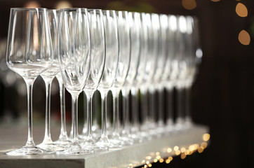 Set of empty glasses on grey table against blurred background