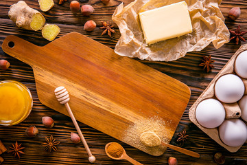 Fototapeta na wymiar Traditional christmas holidays pastry ingredients and various kitchen utensils on wood textured table. Ginger cookies recipe concept. Close up, copy space, top view, flat lay, background.