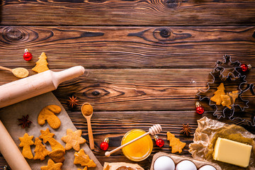 Traditional christmas holidays pastry ingredients and various kitchen utensils on wood textured table. Ginger cookies recipe concept. Close up, copy space, top view, flat lay, background.