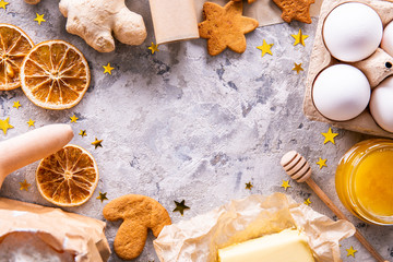 Traditional christmas holidays pastry ingredients and various kitchen utensils on grunged stone textured table. Ginger cookies recipe concept. Close up, copy space, top view, flat lay, background.