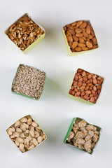 Paper bags with pistachios sunflower seeds walnuts cashew peanut almond pine nuts