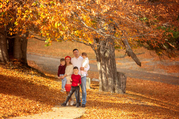 Fototapeta premium Happy family walks in the forest in autumn.