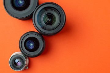 Progress of different photo lenses on a colored background, a set of old and modern photo devices for the camera