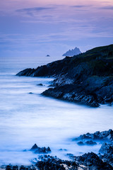 a viewpoint from bray head on valentia island in the ring of kerry in the south west coast of ireland during an autumn sunset showing the skellig islands and watchtower