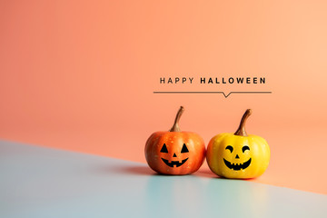 Happy Halloween message, Pumpkin on pastel paper background.
