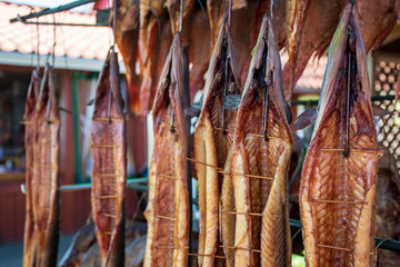 Various dry smoked fresh fish in a market, close up