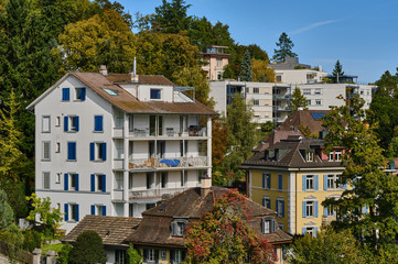 Buildings And Trees In City Against Sky