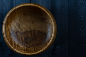 Bowl of wood on a wooden background