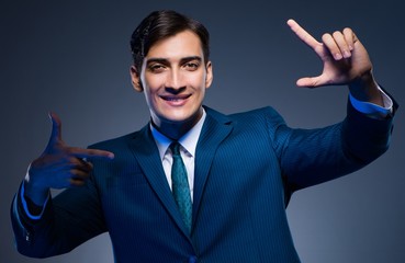 The businessman pressing virtual buttons on gray background