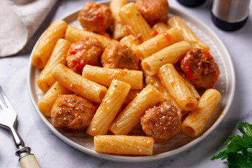 Pasta with meatballs in tomato sauce.
