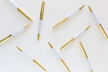 Scattered gold and crystal pens