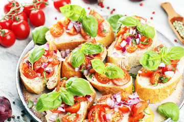 fresh tomato bruschetta. italian food appetizer with basil on table