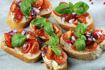 fresh tomato bruschetta. italian food appetizer with basil on table