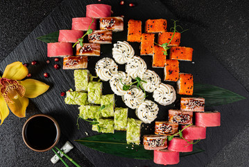 Obraz na płótnie Canvas tasty sushi on the black background