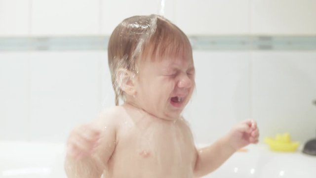 Infant boy doused with water