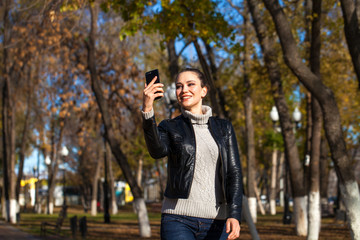 Young beautiful model in a black leather jacket