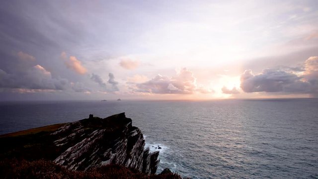 footage of bray head on the ring of kerry in the south coast of ireland on a stormy day showing battering waves and green grass on rocky coastline