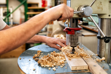 Woodworker or carpenter using a vertical drill