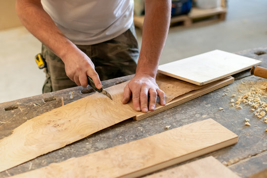 Carpenter cutting a wooden briar root sheet