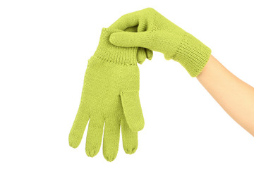 Hand in knitted mitten on white background