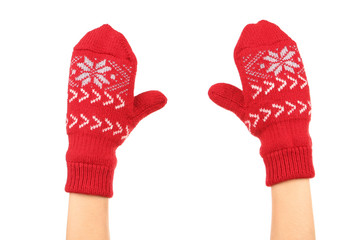 Hands in knitted mittens on white background