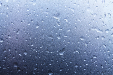 Large raindrops on a metallic silver surface. Texture for creative design.