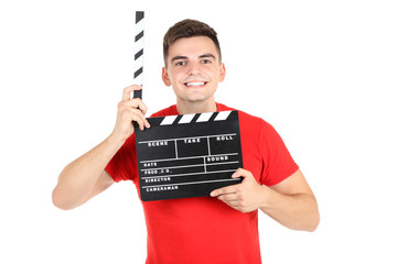 Young man with black clapper board on white background