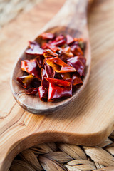 Dried Red Chili -  Hot Spices, macro on wooden spoon.