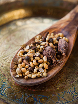Indian Garam Masala -  whole spices, macro on wooden spoon.