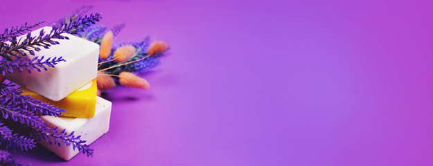 Soap and lavender fon purple background.