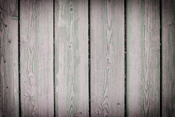 Wooden fence from old boards. Background for sites and advertising. Photo with vignette.
