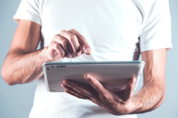 man touching in tablet screen
